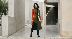 A professional editorial fashion shot of a stylish woman wearing a sophisticated, color-blocked outf