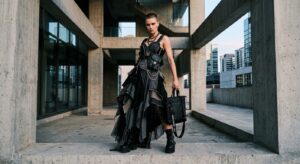 A high-fashion editorial photograph of a model wearing a deconstructed haute couture gown paired wit