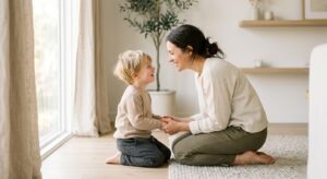 A soft-focus, professional editorial photograph of a mother gently kneeling to make eye contact with
