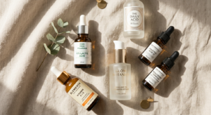A minimalist, editorial-style flat lay featuring various elegant skincare bottles and professional c