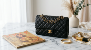A high-end editorial still life of a luxurious designer handbag placed elegantly on a marble surface