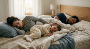 A soft, editorial-style photograph of a peaceful toddler sleeping soundly in a cozy, minimalist bed